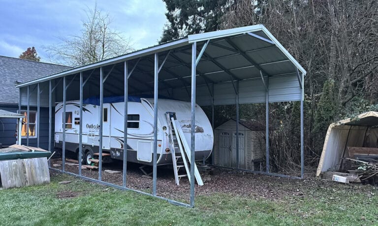 RV parked under large metal shelter