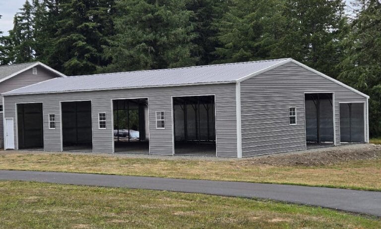 Gray metal building with open garage doors