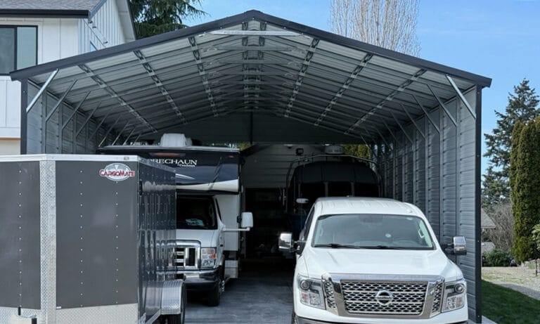 Metal carport sheltering vehicles and a trailer.