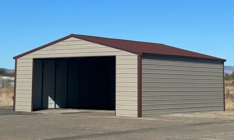 Large metal storage shed on concrete ground.