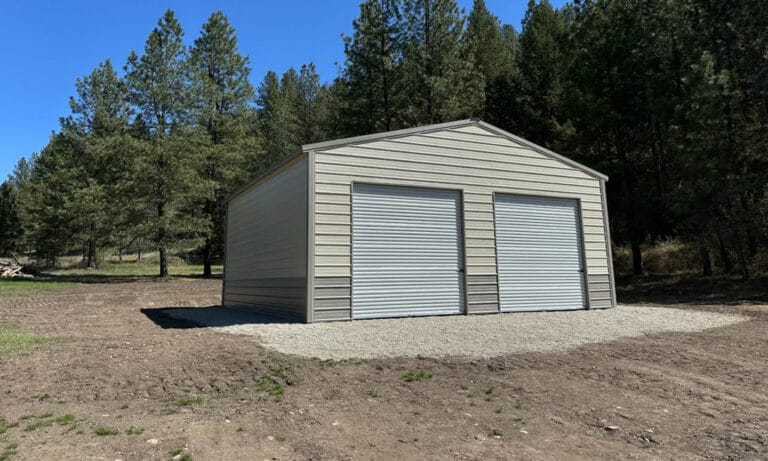Metal shed with two roll-up doors in forest