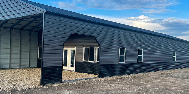 Large metal building under blue sky.