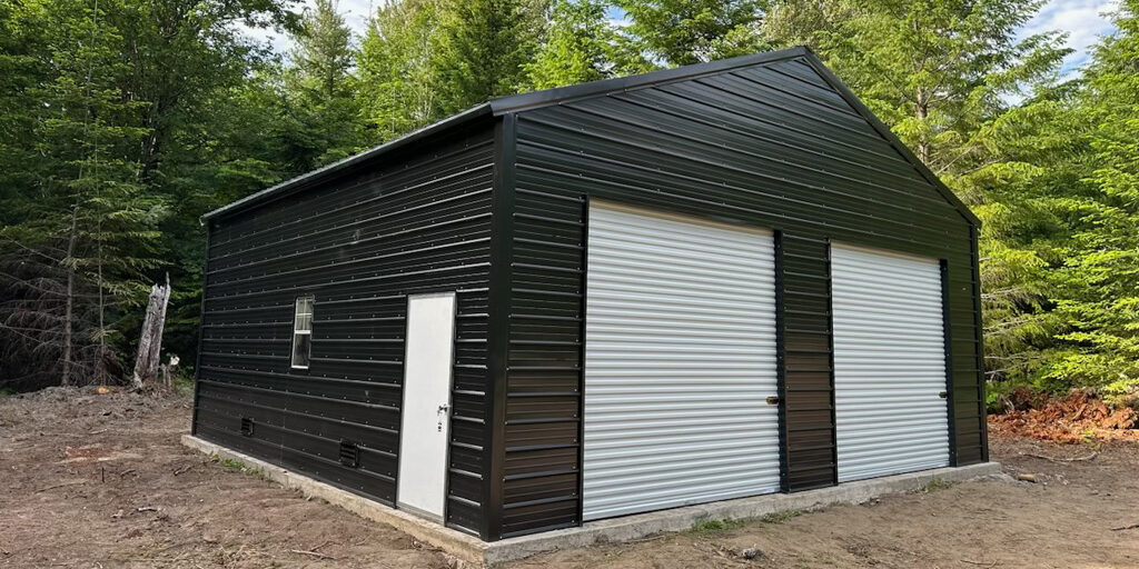 Black metal shed with two white doors in forest.